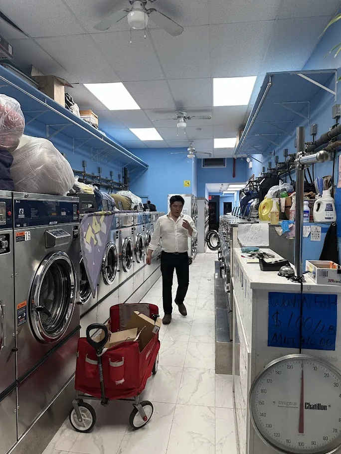 Inside the laundromat with the wash-and-fold price board