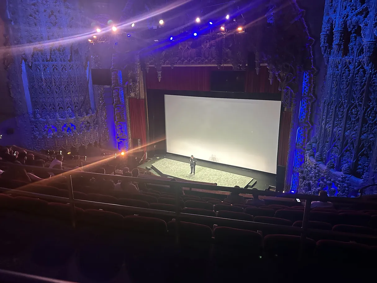 Inside the United Theater, looking down at the stage and screen from the balcony